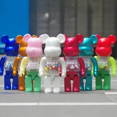 Twelve glossy collectible bear figures in blue, gold, white, pink, green and red, in three rows