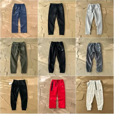 Nine pairs of jogger sweatpants in blue, black, grey, olive, red and cream, arranged in three rows